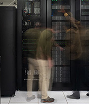 Two people examine ARM's high-performance computing cluster.